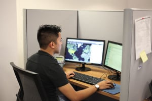 Man sitting at a desk looking at a computer
