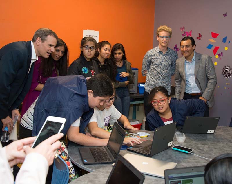 Salesforce.org executives Rob Acker (CEO) and Josue Estrada (SVP Marketing and Industry Solutions) volunteer with local school kids at a STEM education event.