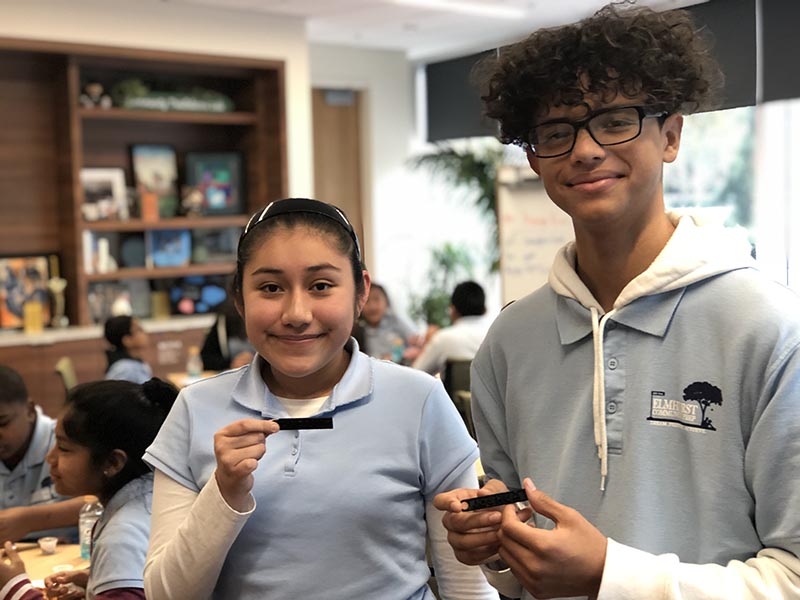 Students from OUSD proudly showcasing their 3D printed keychains in a Computer Science Education Week event at Salesforce