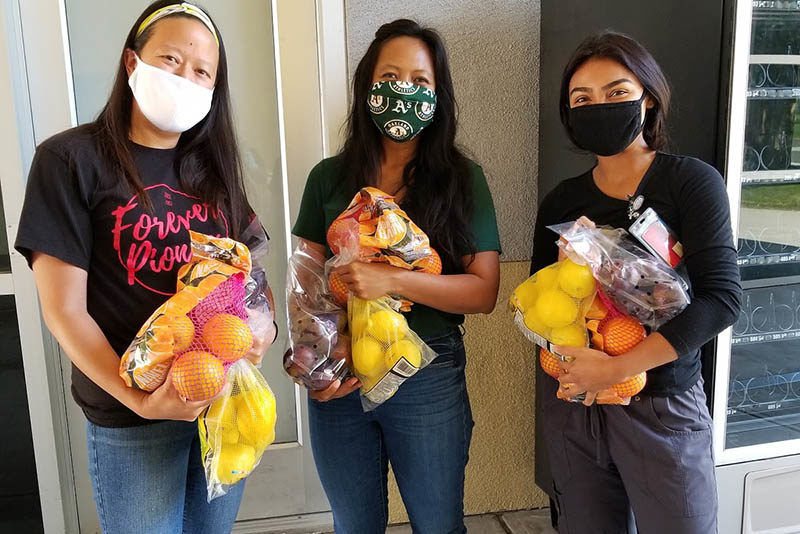 Cal State East Bay students who are remaining on campus distribute fruit as part of the emergency assistance program.