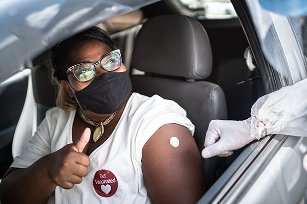 Woman getting vaccine shot in her car