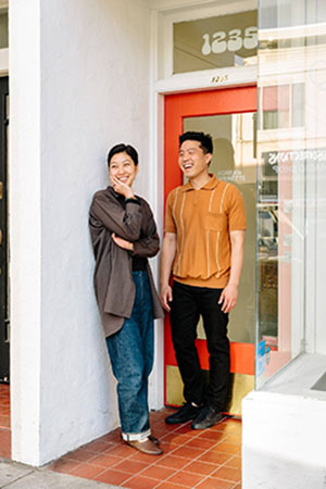 Two people standing in a doorway smiling