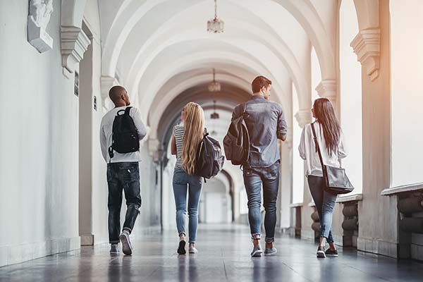 College students walking down a hallway talking