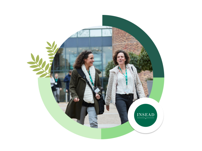 two staff members walking on the INSEAD campus